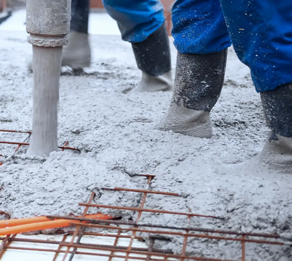 Arbeidere som fyller gulv med betong