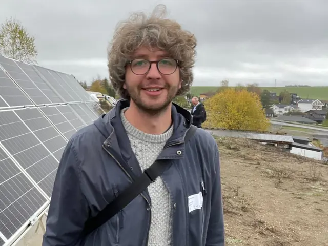 Mann med krøllete hår og briller