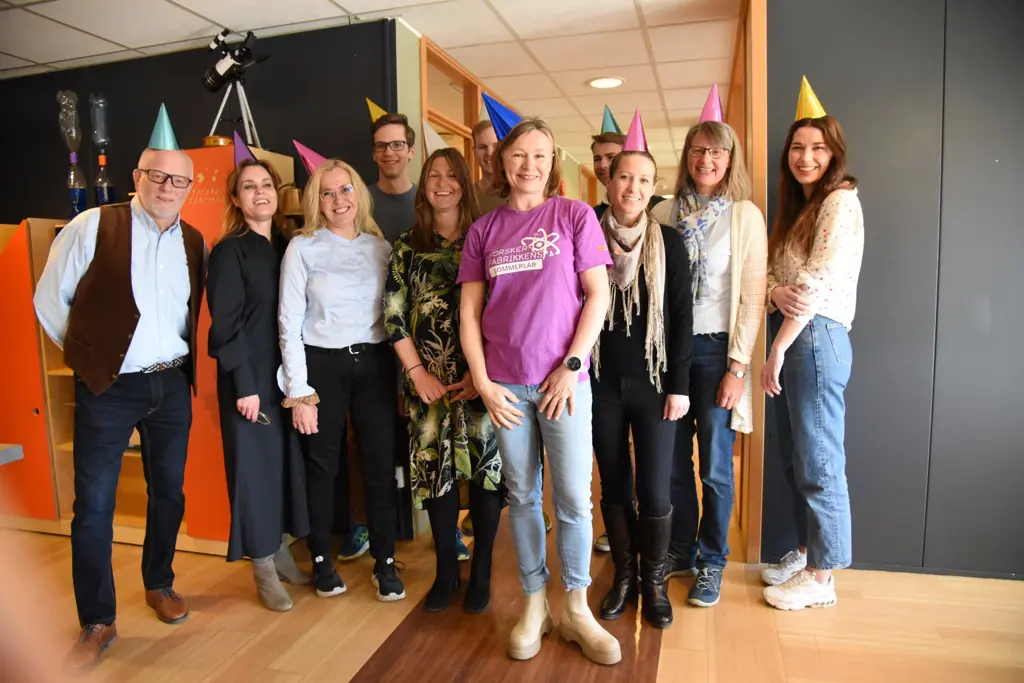Hanne Finstad with colleagues with party hats