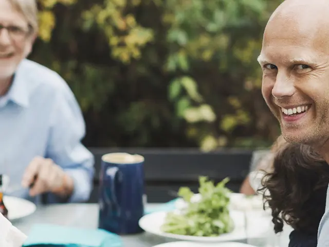 Familie samlet rundt et middagsbord ute på sommeren