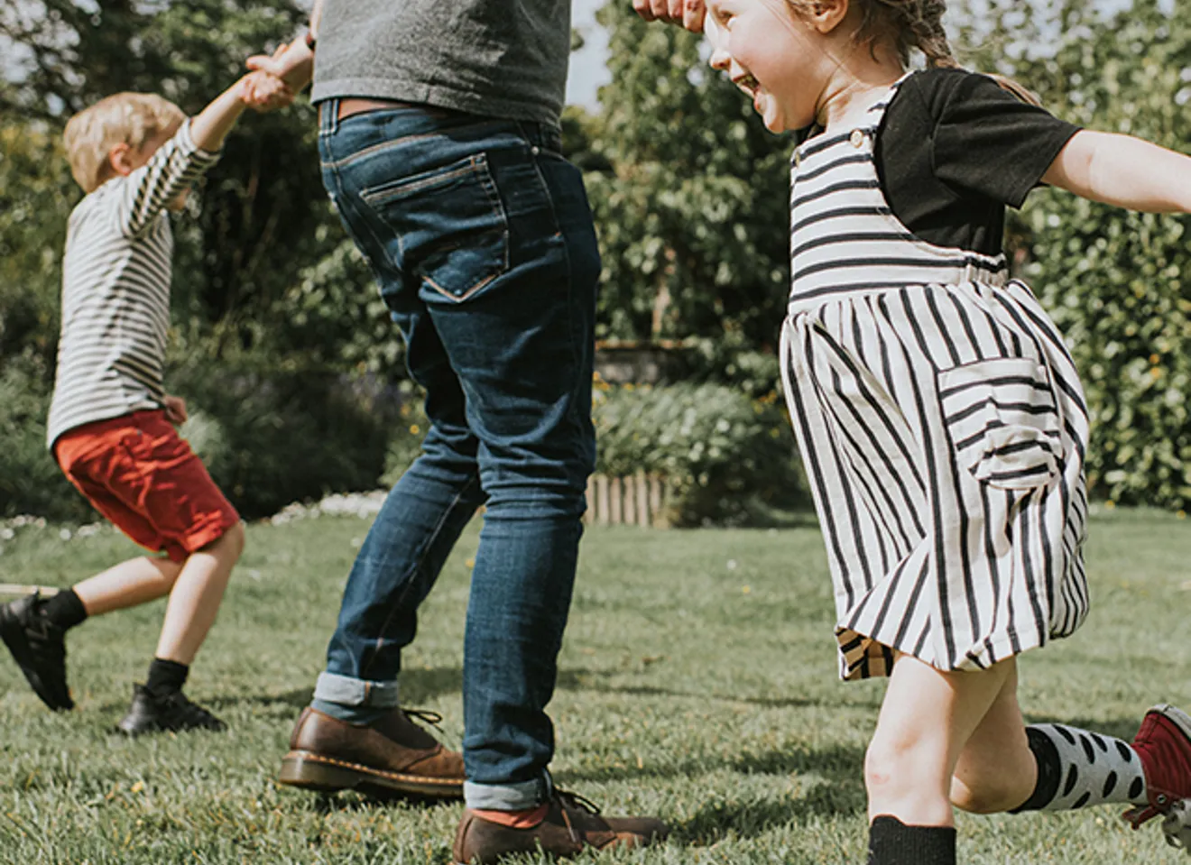 Pappa som leker i hagen med barna sine
