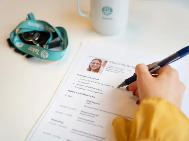 En hånd som noterer på en CV