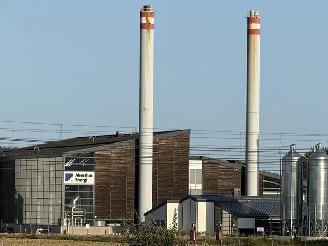 Biovarmeanlegg og fjernvarmeanlegg drevet av biomasse, med industribygg og piper ved Akershus Energi.