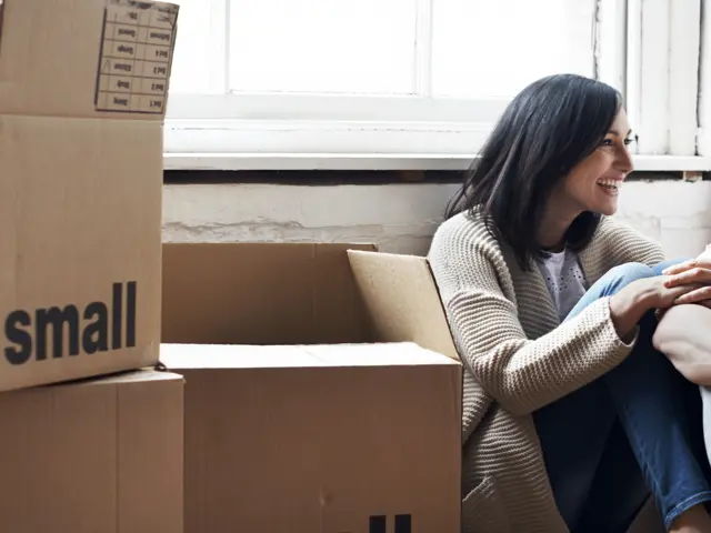 Kvinne som sitter ved flytteesker