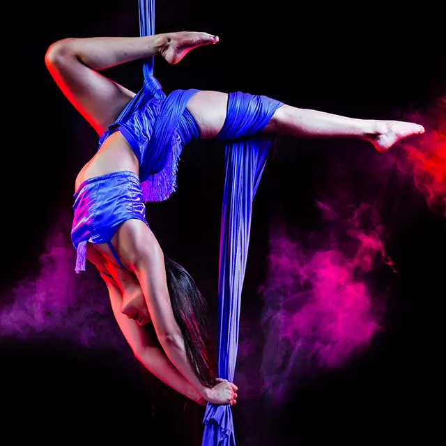 Dame som henger i taket i silkestoff, luftakrobatikk, henger opp ned