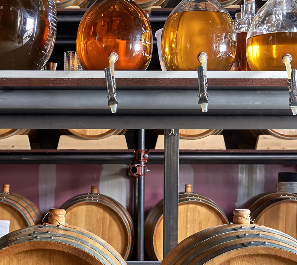 Foto av alkohol i falkonger og lagringstønner på destilleri