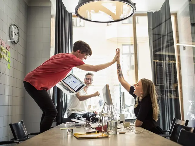 Kollegaer som gir hverandre "high-five"